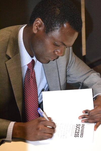 Davies Chibale signing book